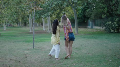 two women friends enjoying a day out in the park