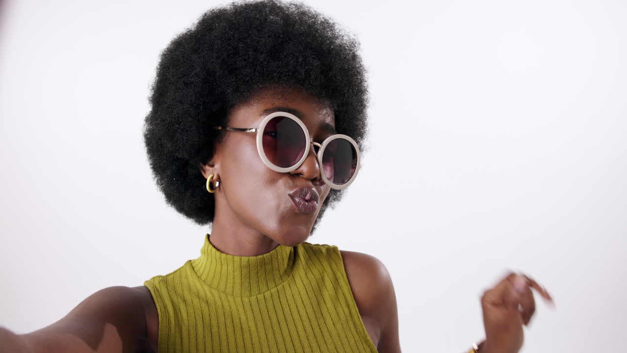 Woman with Afro and Sunglasses Taking Selfie