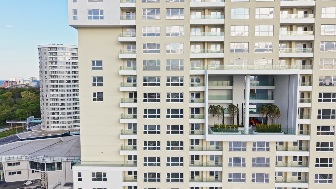 Vista de um complexo de edifícios modernos em uma cidade, com atenção focada na arquitetura e na área circundante durante o dia.