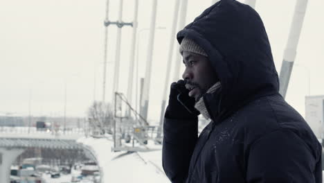 young person talking on the phone outdoors