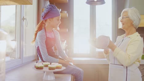 Grandma-letting-little-girl-to-smell-freshly-baked-muffins-4K-4k