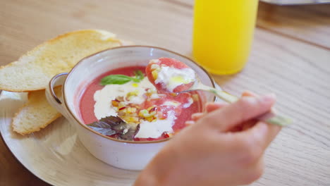 woman eating gazpacho soup