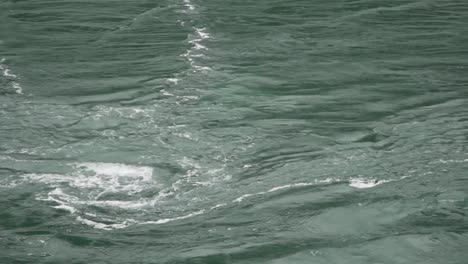 fast flowing green river water at deception pass in washington state