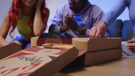 Studio-Shot-Of-Young-Gen-Z-Friends-Sitting-On-Sofa-With-Home-Delivery-Takeaway-Pizza-1