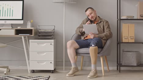 businessman with prosthetic leg working at home office