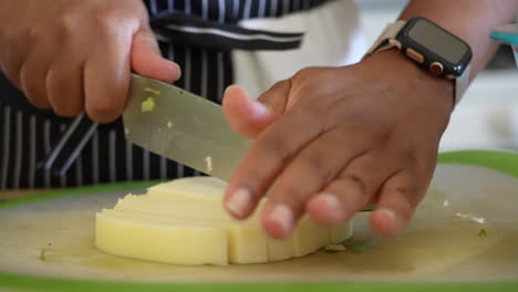 slicing a white mild cheese for a chopped salad - antipasto salad series