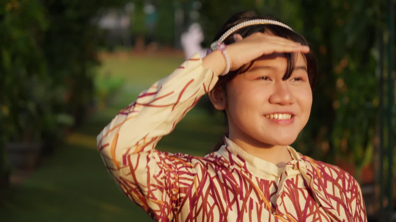 Happy Young Asian Girl in Garden