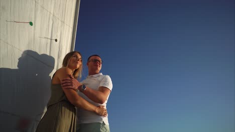 couple posing on a sailboat deck