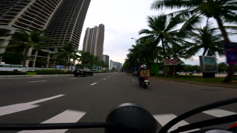 da nang, vietnam - riding a scooter through the city with a view of the marble mountains - pov