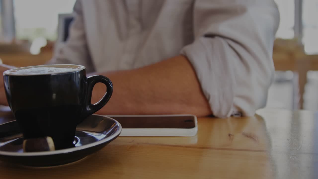 Man reacting to fading bar charts floating over cup and keyboard while typing for business analysis