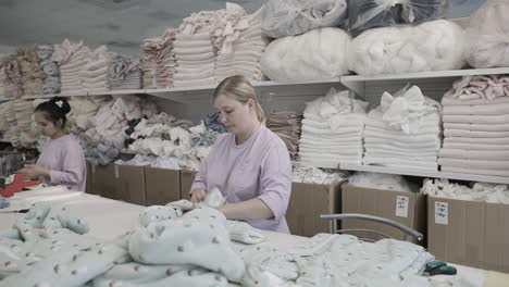 textile factory workers producing baby clothes