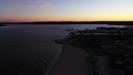 an-aerial-shot-over-an-empty-beach-during-a-beautiful-sunrise