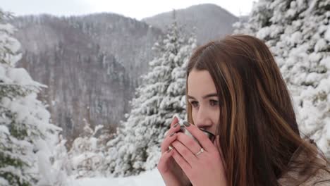 young pretty girl drinks hot tea on the date in winter forest young pretty girl drinks hot tea on the date in winter forest