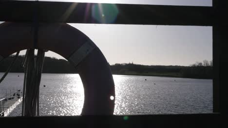 view of lake through safety buoy and rope medium shot