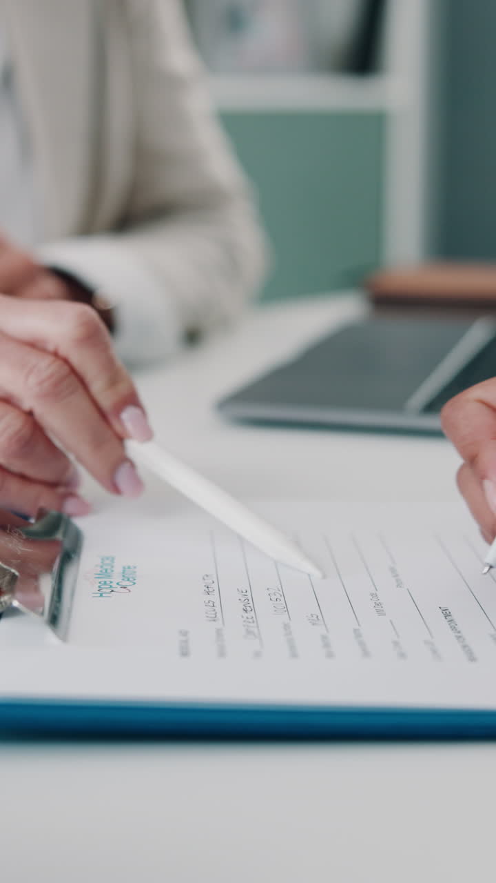 Hands Filling Out Medical Registration Form with a Stylus