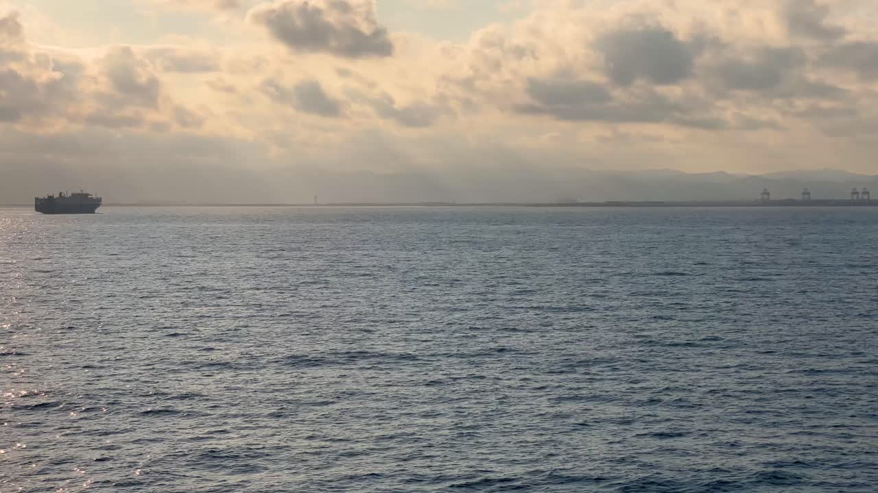 Cruise ship in the middle of the ocean at sunset silhouette peace tranquility