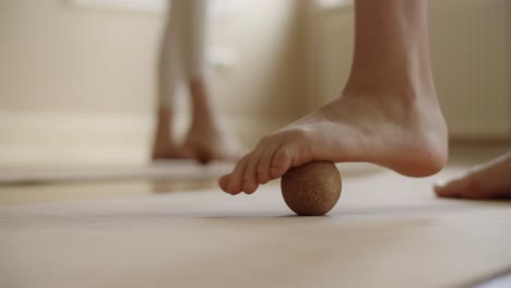 foot balance exercise with massage ball