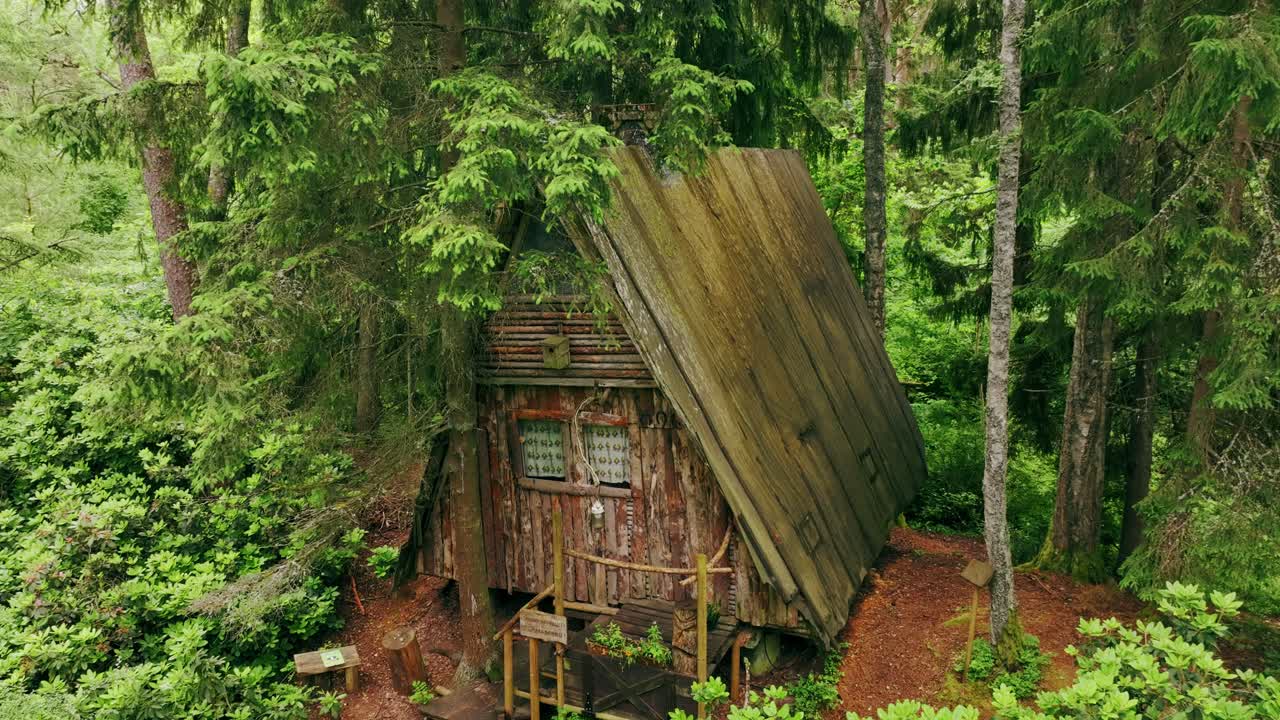 Drone Moves Closer to Wooden A-Frame Cabin – Quiet Green Forest in Latvia