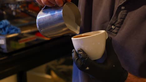 barista making a latte