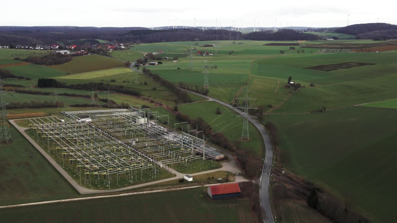 Critical Infrastructure: Aerial View of Powerlines Connecting Windmills to a Power Substation in the German Power Grid in Sauerland, Germany