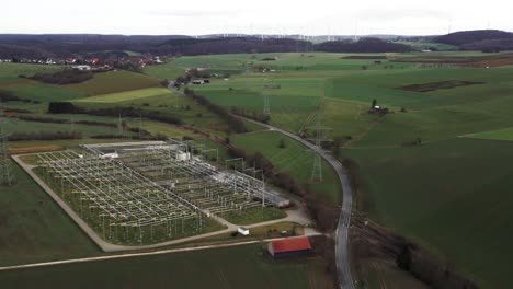 critical infrastructure: aerial view of powerlines connecting windmills to a power substation in the german power grid in sauerland, germany