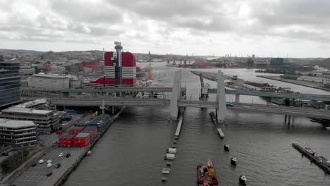 aerial descending shot capturing the vehicles on newly built infrastructure hisingsbron bridge crossing the gota river, in gothenburg metropolitan area, sweden