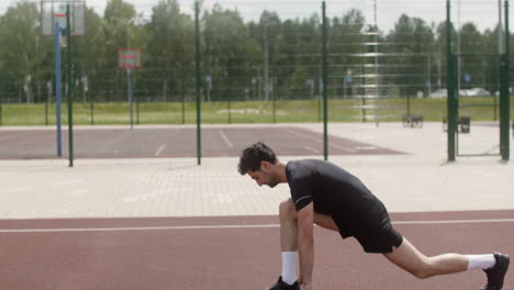 side view of brunet man stretching