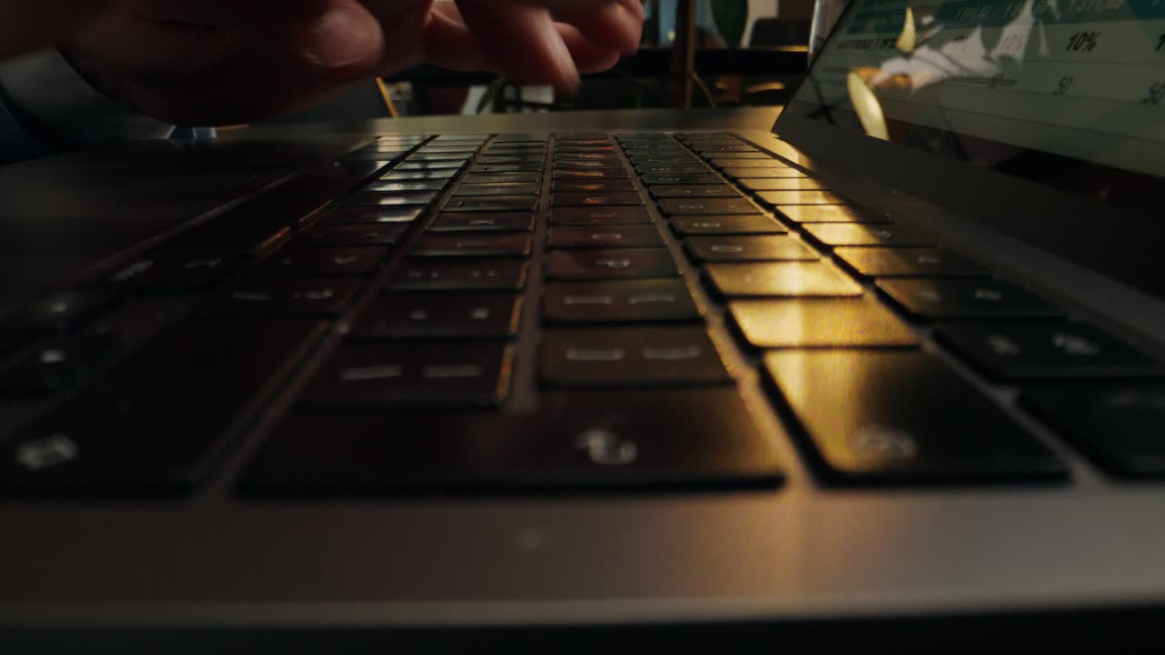 Person Typing on Laptop Keyboard