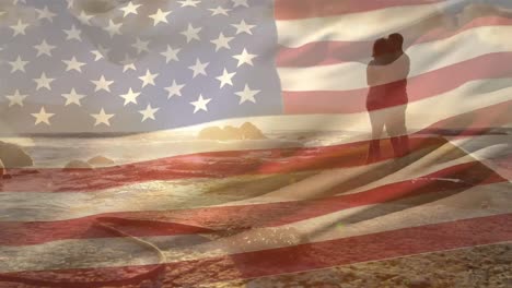 animación de la bandera de los estados unidos sobre una pareja afroamericana en la playa
