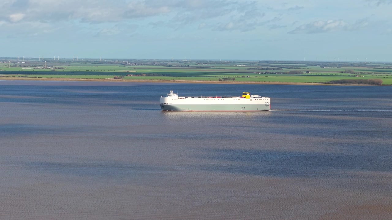Aerial view of a large passenger and vehicle roll-on roll-off ferry ship sailing down the River Humber towards the Port of Immingham, Lincolnshire, UK.