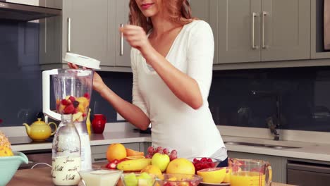 happy woman making smoothie