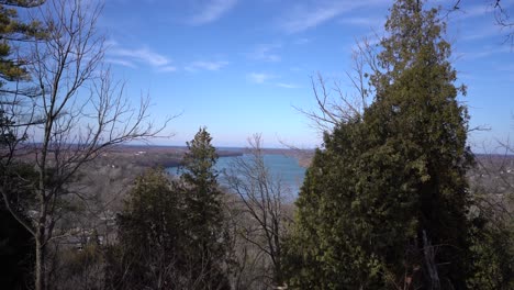 View-of-Niagara-River-from-Queenston-Heights-Park-in-Niagara-region---Niagara-Parks-Queenston-Heights-view-from-hill-monument-lookout-with-bird-flying-by-in-sky-4k