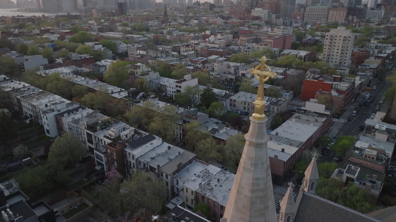 Aerial view of a crucifix on a church steeple in Brooklyn. Shot on a spring day.