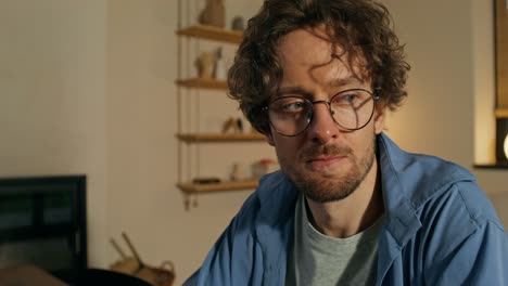 man sitting at home drinking coffee