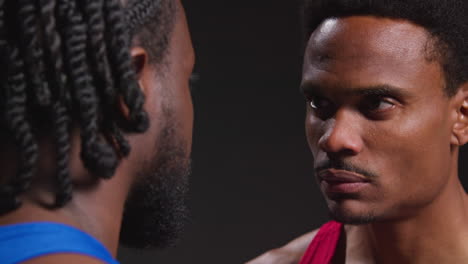 Close-Up-Of-Male-Boxer-And-Opponent-Standing-Face-To-Face-Before-Boxing-Match-Staring-At-Each-Other-3