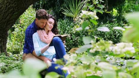 romantic couple reading novel in park