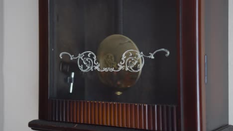 pendulum swinging on an old pendulum clock