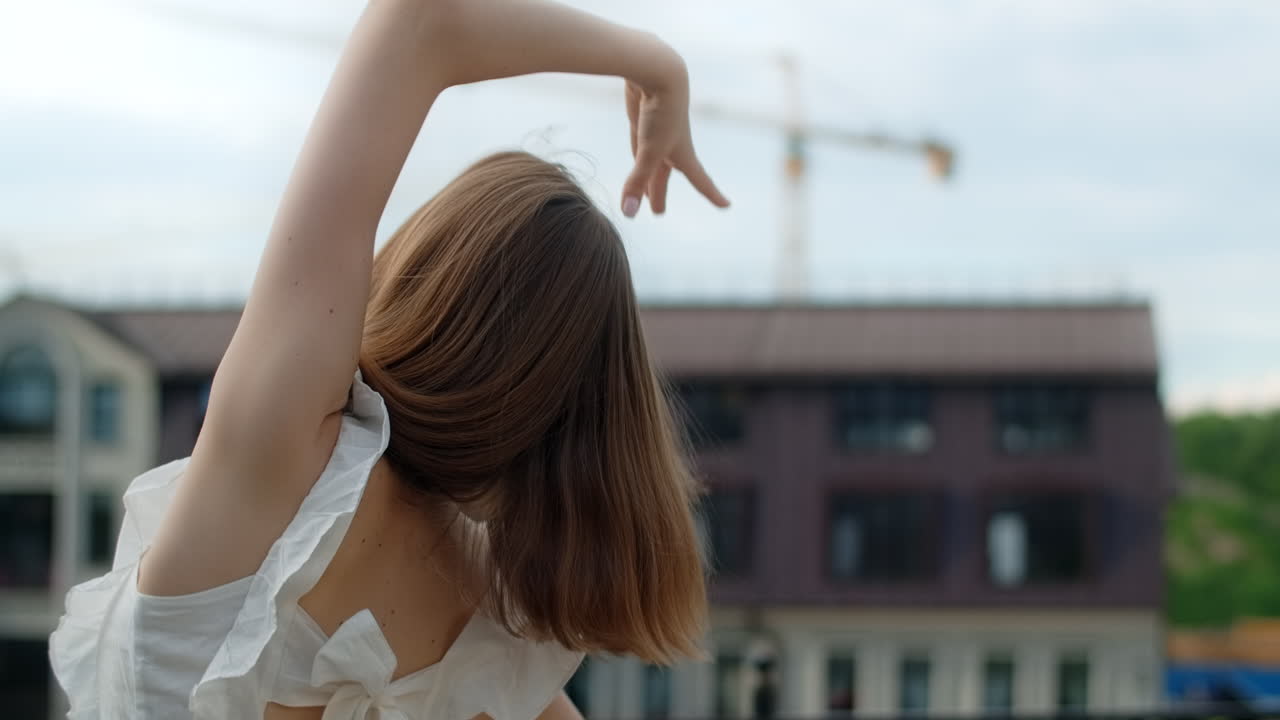 Young Woman Dancing in Urban Setting