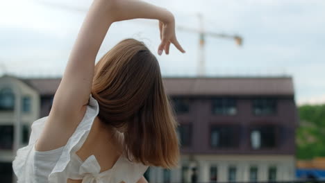 young woman dancing in urban setting