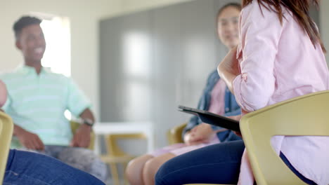 diverse students engage in a discussion at high school