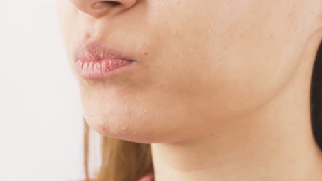 woman eating chocolate dragee in close-up. chocolate.