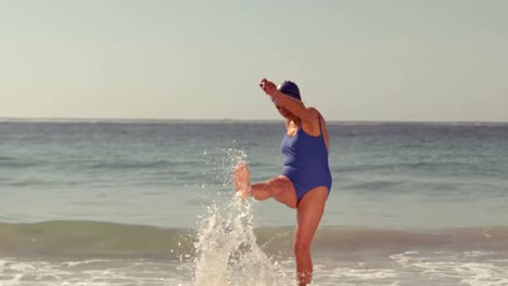 Happy-senior-woman-shooting-in-waves