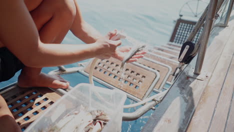 cook on yacht ship cleans fresh caught fish for delicious seafood meal