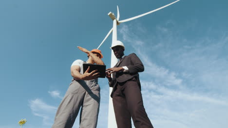 engineers inspecting wind turbine