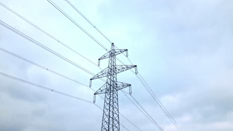 transmission tower and overhead power line against clear sky in daytime