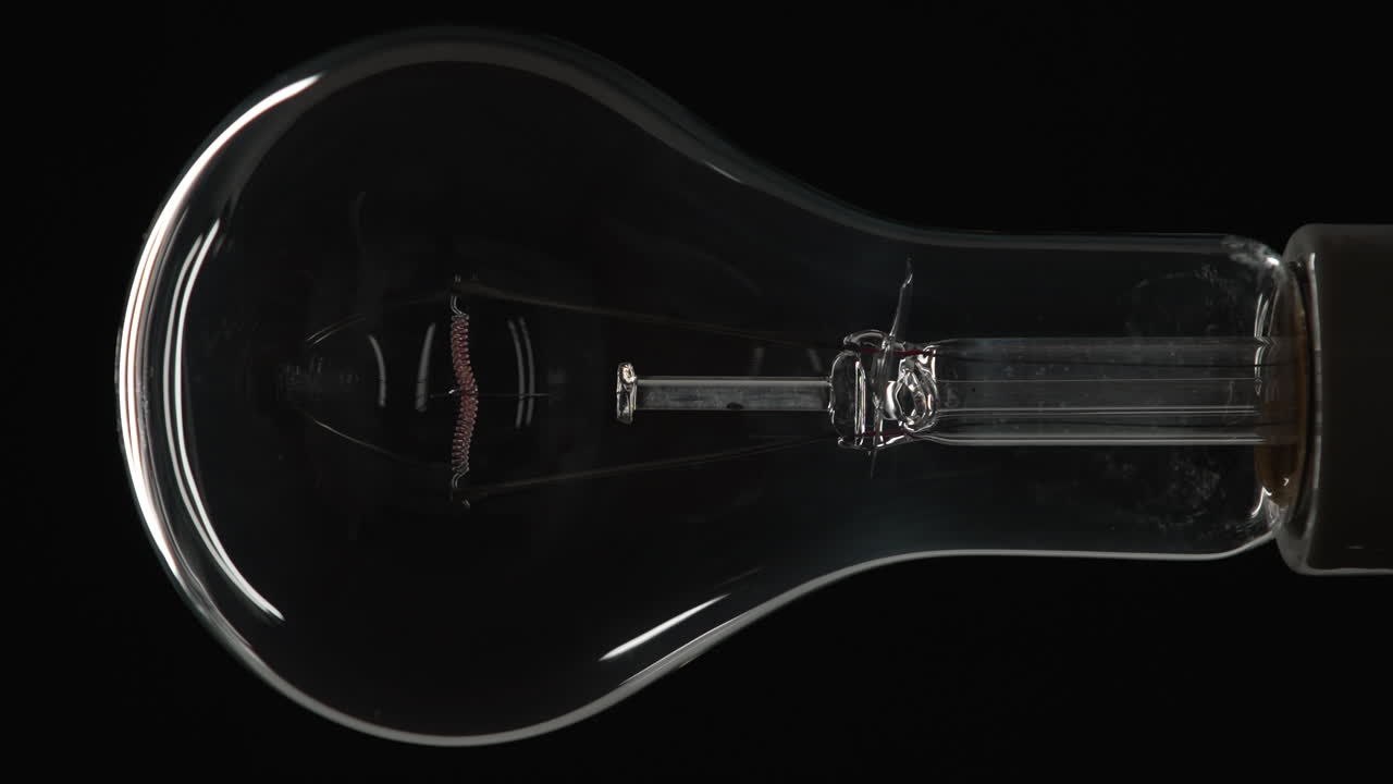 Clear Incandescent Lightbulb Dimming Up and Turning Off