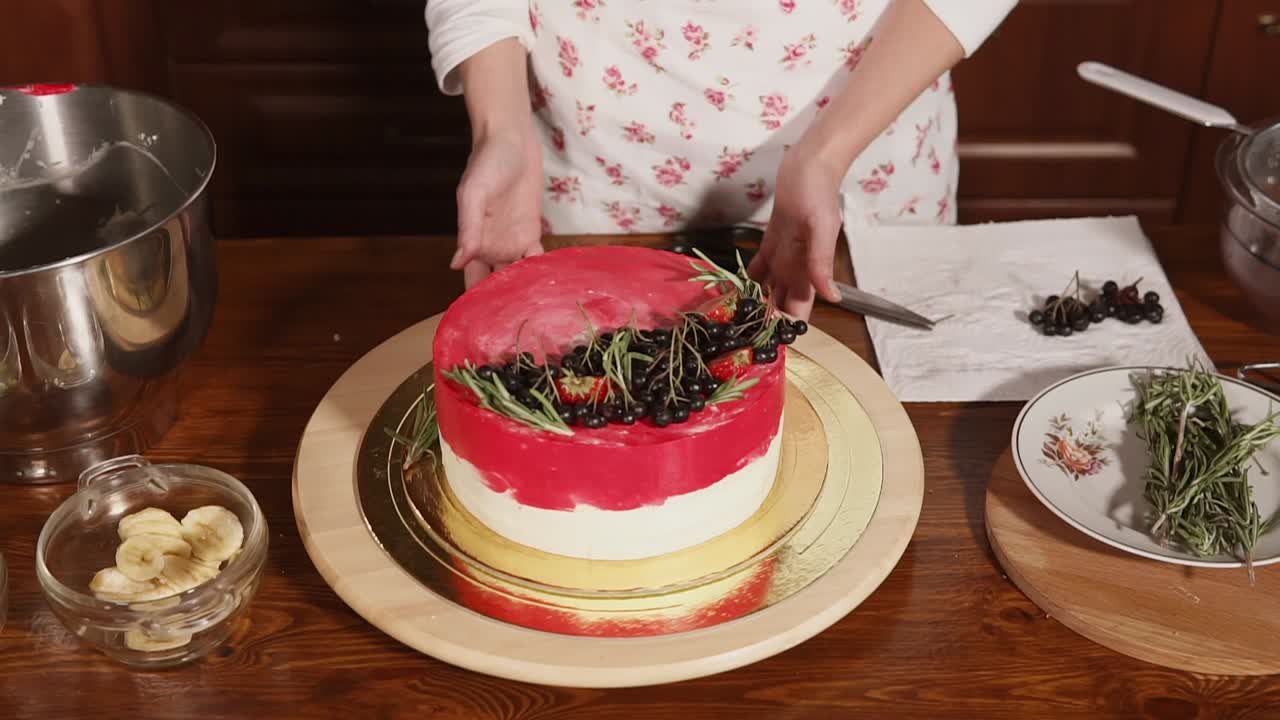 신선 한 베리 와 로즈마리 로 아름다운 케이크 를 장식 하는 여자