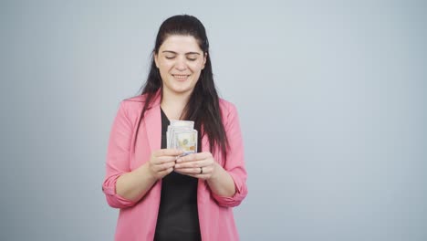 Business-woman-counting-money-looking-at-camera.