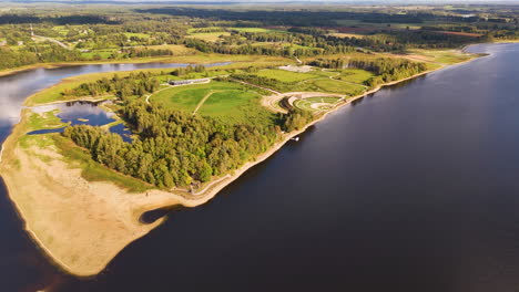 aerial flying towards liktendarzs, garden of destiny, on sunny day, koknese, latvia