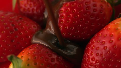 chocolate sauce pouring over strawberries